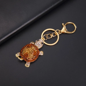 Detailed macro view of turtle keychain with sparkling orange and brown rhinestones