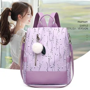 Sac à dos imperméable violet à fleurs pour femme avec pompon blanc et zip de sécurité