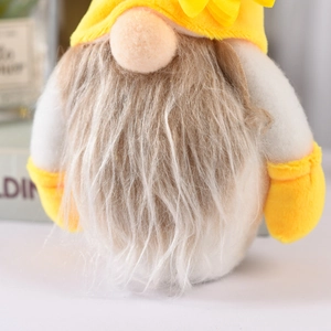Close-up of a gnome plush with a yellow sunflower hat and fluffy brown faux fur beard
