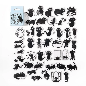 Detailed macro view of assorted cute black and white cat stickers for DIY journals