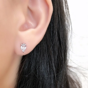 Close-up of elegant S925 sterling silver pear-cut zircon stud earring on ear