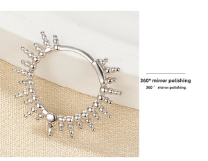 Detailed macro view of 360-degree mirror polished S925 silver hoop with sunburst bead trim