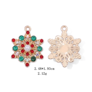 Detailed view of snowflake earrings with red and green rhinestones and a white pearl