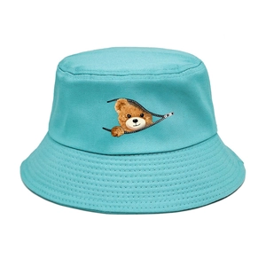 Close-up of bear zipper print and stitch texture on blue cotton bucket hat