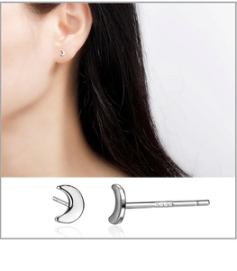 Close-up of S999 sterling silver crescent stud earrings featuring a minimalist polished finish
