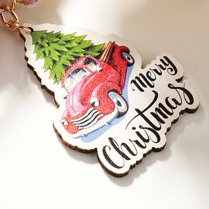 Retro Christmas wooden keychain with red truck and Christmas tree design on white background