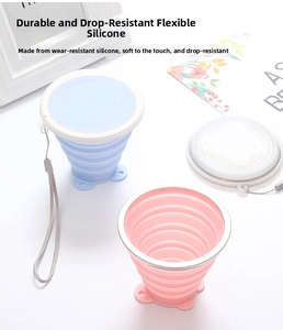 Close-up of flexible pink and blue collapsible silicone travel cups with lanyards