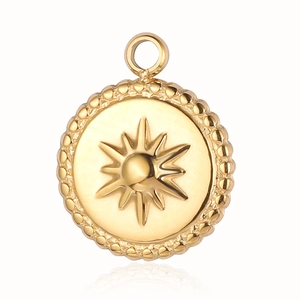 Detailed view of a gold-plated sunburst pendant with beaded edges on a white background