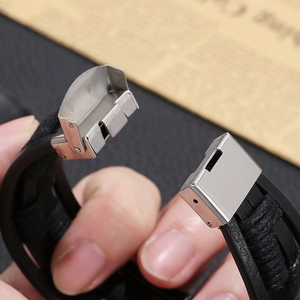 Detail of multi-layer braided leather bracelet with black magnetic stainless steel clasp