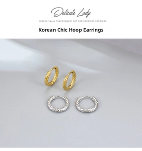 Detail of mini textured hoop earrings in gold and silver with a refined hammered finish