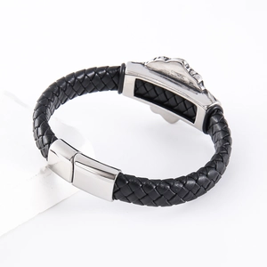 Men's black braided leather bracelet with a silver magnetic clasp on a white stone base