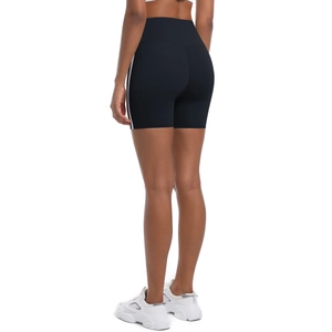 Detail of high-waisted black yoga shorts featuring white side stripes and supportive back fit