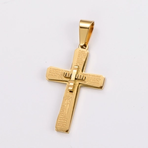 Macro shot of gold layered cross pendant with engraved Spanish Lord's Prayer text