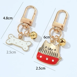 Christmas dog bone and cat bells zinc alloy keychains with size dimensions on white background