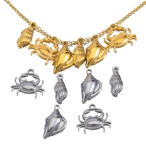 Ocean-themed stainless steel charms including golden necklaces and silver sea life pendants