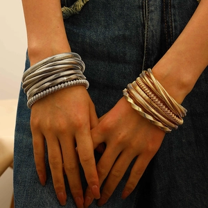 Exaggerated chunky spring cuff bracelet in gold and silver finish with spiral snake chain texture