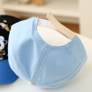 Detail of adjustable Velcro strap and twill cotton fabric on light blue kids baseball cap