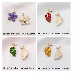 Detail view of colorful DIY enamel maple leaf and flower pendants with size measurements