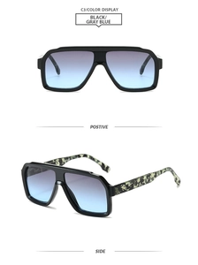 Detail of square sunglasses with black frames and blue-gray gradient lenses and camo temples