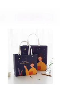 Detail of purple Teachers' Day gift bags with illustrations and gold rivets on a desk