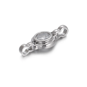 Macro shot of silver circular zircon charm accessory with dual connection rings for DIY jewelry