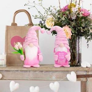 Detail of two pink Mother's Day gnomes with tulips and Best Mom Ever heart on wooden table