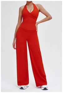 Detail of orange high-waist yoga pants and halter neck top in high-stretch fabric