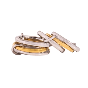 Detailed view of interlocking gold and silver stainless steel rings with a polished finish