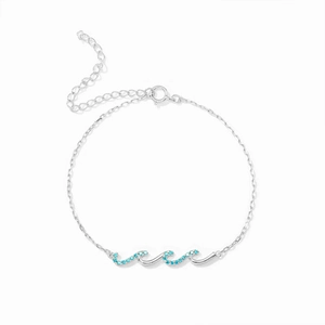 Détail macro du bracelet vague en argent avec gemme bleue et chaîne de rallonge