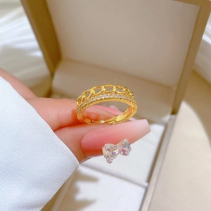 Macro detail of gold plated chain ring with shimmering pave crystals on a jewelry box