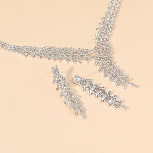 Sparkling silver-tone rhinestone necklace and earrings set featuring leaf pattern design
