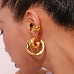 Hammered texture gold earrings and ear cuff set shown on a model for a modern look