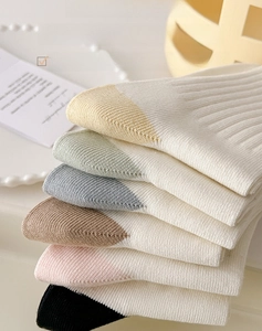 Close-up of premium combed cotton socks with ribbed cuffs in various soft colors