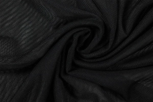 Close-up of black mesh fabric texture showing breathable pores and soft drape on the dress