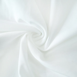 Close-up macro of white knit fabric texture and soft drapery on this sexy dress
