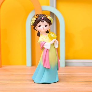 Chinese style ancient Tang costume doll figurine with fan on yellow background