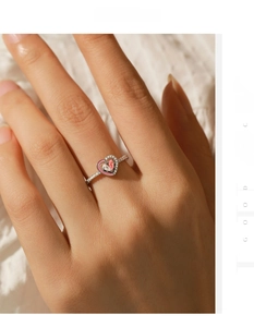Close-up of s925 silver heart ring with pink enamel and pave-set zircons on hand