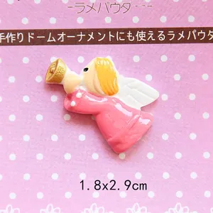 Macro view of a small resin angel charm for DIY crafts, size 1.8x2.9cm with golden hair