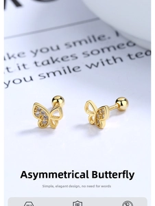 Macro shot of gold butterfly stud earrings with zircon inlay and screw ball backings