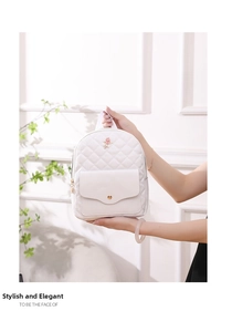 Close-up of quilted floral mini backpack in warm white with rose metal detail