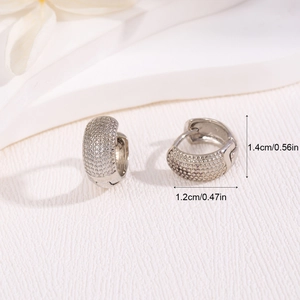 Silver textured hoop earrings with dimensions 1.4cm by 1.2cm on white background