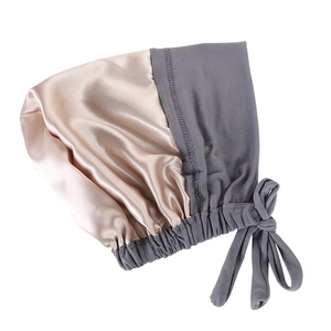 Detail of champagne gold and grey satin sleep cap with adjustable silk ribbons