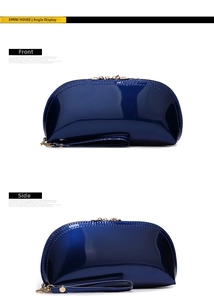 Detail view of the navy blue shell-shaped makeup bag showing front and side angles