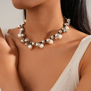 Adjustable faux pearl and silver metal bead necklace on model with vintage aesthetic