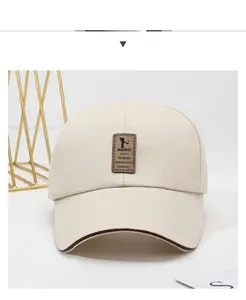 Detailed front view of a cream cotton baseball cap with a vintage brown leather logo patch
