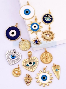 Detail of assorted gold-plated Evil Eye charms with colorful enamel and micro zircon inlay