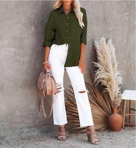 Army green V-neck long-sleeve cotton linen shirt shown in a rustic studio setting