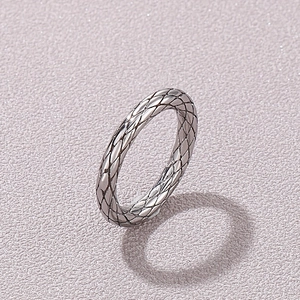 Detail of silver titanium steel ring featuring creative vintage rhombus grid texture