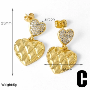 Detailed view of gold heart earrings with zircon inlay and quilted texture and 25mm size