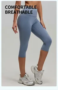 Detail view of high-waisted gray-blue capri yoga pants with peach lift effect for fitness